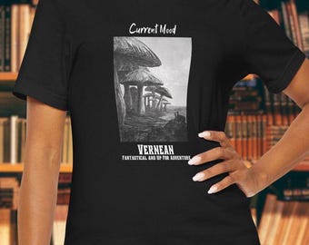 May include: Black t-shirt with a graphic of mushrooms in a forest. The text "Current Mood" and "Vernean Fantastical and Up for Adventure" is printed on the shirt.
