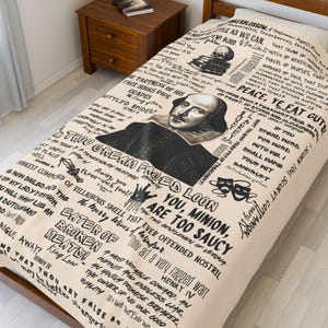 May include: Beige Shakespeare-themed duvet cover with black text and illustrations. Features a portrait of Shakespeare, quotes, and imagery from his plays. The bedspread is on a wooden bed frame.