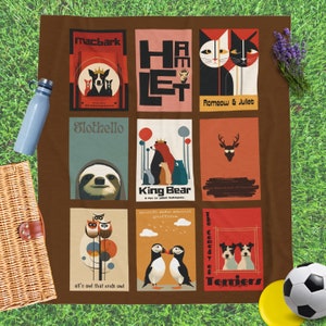 May include: A brown picnic blanket with nine colorful squares featuring illustrations of animals and text from Shakespeare plays. The squares include Macbark, Hamlet, Romeow & Juliet, Slothello, King Bear, The Merchant of Venice, much ado about puffine, all's owl that ends owl, and The Comedy of Terriers.