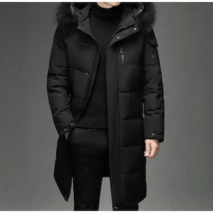 May include: A black long puffer coat with a fur-trimmed hood. The coat has a zip fastening and multiple pockets.