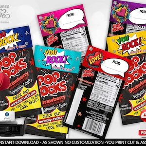 May include: Several Pop Rocks candy packets with vibrant designs. Each packet displays the text "YOU ROCK!" or "LOVE!" in a comic book style. The packets are black with strawberry flavour information and a website address for a chance to win prizes.