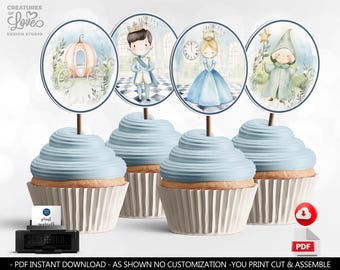 May include: Four blue cupcake toppers with Cinderella and Prince Charming themed illustrations. The toppers feature a pumpkin carriage, a clock, a fairy godmother, and a prince. The toppers are printed on white cardstock and are ready to be cut out and assembled.