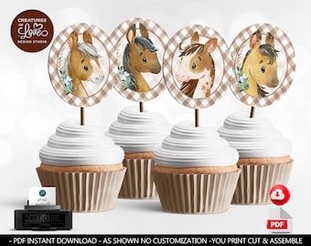 May include: Four cupcakes topped with horse-themed decorations. Each cupcake has a white swirl of frosting and a brown paper liner. The toppers feature watercolor illustrations of horses within a brown and white checkered oval. The text "CREATURES OF LOVE DESIGN STUDIO" is visible.