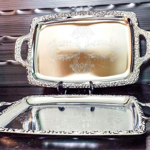 Vintage 2 × serving platters/trays made of metal with handles, edge decoration and base engraving in original packaging/Practica series by Quelle.