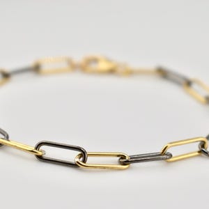 Bracciale bicolore con graffetta in oro e argento ossidato
