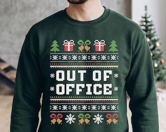 May include: A dark green crewneck sweatshirt featuring a white, red, and gold holiday-themed pattern. The design includes the text "OUT OF OFFICE" centered, surrounded by pixelated graphics of Christmas trees, gift boxes, bells, and snowflakes.