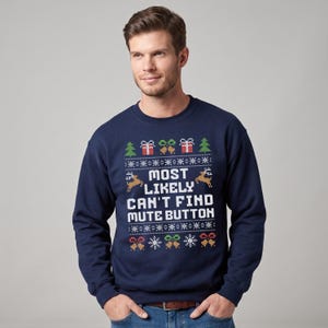 May include: A navy blue long-sleeve sweatshirt featuring a white, red, green, and gold holiday-themed knit pattern. The center text reads, "MOST LIKELY CAN'T FIND MUTE BUTTON," surrounded by graphic icons of reindeer, Christmas trees, gifts, and snowflakes.