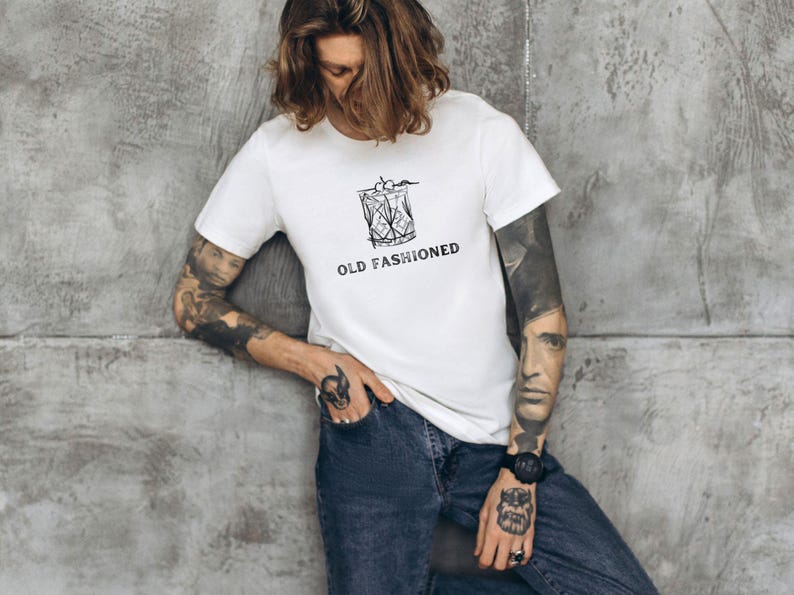May include: White t-shirt with a black and white illustration of an old fashioned cocktail glass and the text "OLD FASHIONED".