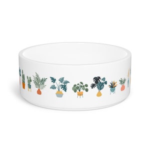 May include: White ceramic pet bowl with a colorful illustration of potted plants around the rim.