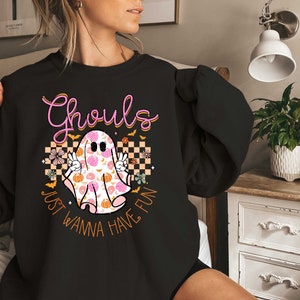 May include: Black sweatshirt with a pink and orange ghost graphic and the text "Ghouls Just Wanna Have Fun".
