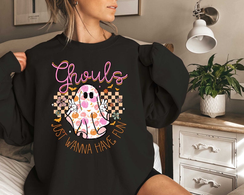 May include: Black sweatshirt with a pink and orange ghost graphic and the text "Ghouls Just Wanna Have Fun".