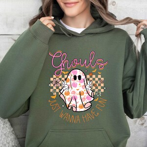 May include: Green hooded sweatshirt with a pink and orange graphic of a ghost with the text "Ghouls Just Wanna Have Fun".