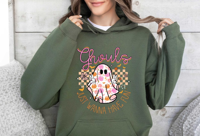 May include: Green hooded sweatshirt with a pink and orange graphic of a ghost with the text "Ghouls Just Wanna Have Fun".