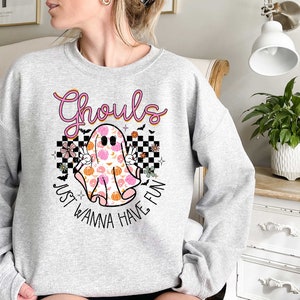 May include: A gray sweatshirt with a pink and orange ghost graphic and the text "Ghouls Just Wanna Have Fun".