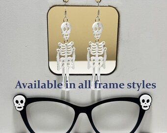 May include: White skeleton earrings and black eyeglasses with skull accents are displayed. The text "Optional Earrings also in black" and "Available in all frame styles" are also visible.