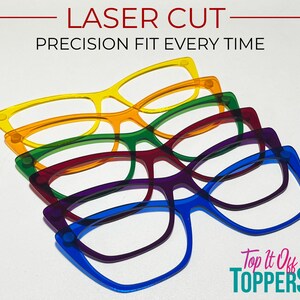 May include: A stack of colorful, laser-cut eyeglasses frames in yellow, orange, green, red, purple, and blue. The text "LASER CUT PRECISION FIT EVERY TIME" is at the top. The logo "Top it Off Toppers" is at the bottom.