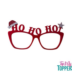 May include: Red novelty glasses with the words "HO HO HO" across the top. A Santa hat is on the left side and a silver glitter star is on the right. The glasses are a festive accessory.