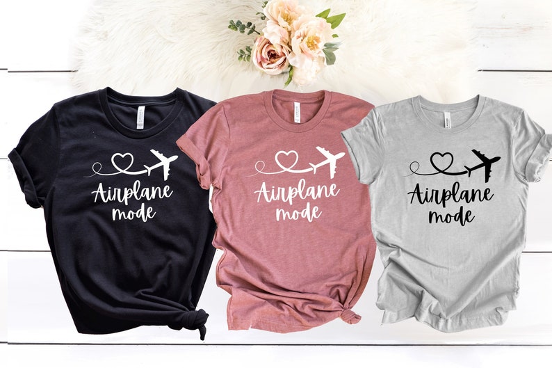 May include: Three t-shirts with the text "Airplane mode" and a heart with a plane flying through it. The shirts are black, pink, and gray.