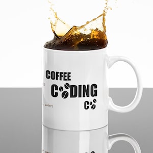 May include: White ceramic mug with a black design that says "Coffee Coding" with coffee beans as the "O" in coding. Coffee is splashing out of the mug.