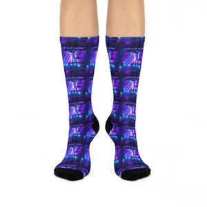 May include: A pair of black socks with a repeating pattern of a stage with purple and blue lights. The socks are made of a soft, comfortable material and are perfect for everyday wear.