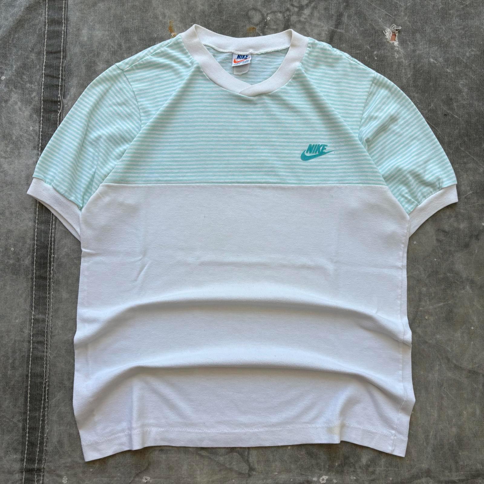 white and turquoise nike shirt