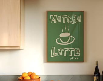 May include: A framed green poster with white text that reads "MATCHA LATTE" with a stylized drawing of a cup of coffee. The poster is hanging on a white wall above a marble countertop with a bowl of oranges and two bottles of wine.