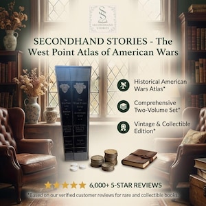 May include: A two-volume set of "The West Point Atlas of American Wars" books. The books are black with gold lettering and are displayed with a leather-bound journal and stacks of coins. The image also includes the text "SECONDHAND STORIES".