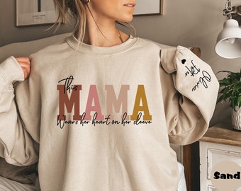 Custom This Mama Wears Her Heart On Her Sleeve Hoodie, Personalized Mom Sweatshirt With Kids Names, Cute Momma Outfit, Mothers Day Gifts