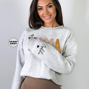 Custom This Mama Wears Her Heart On Her Sleeve Hoodie, Personalized Mom Sweatshirt With Kids Names, Cute Momma Outfit, Mothers Day Gifts image 3