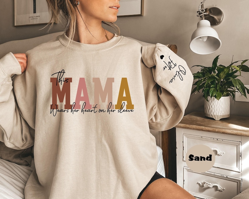 Custom This Mama Wears Her Heart On Her Sleeve Hoodie, Personalized Mom Sweatshirt With Kids Names, Cute Momma Outfit, Mothers Day Gifts image 1