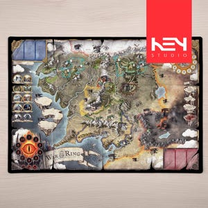 May include: A rectangular board game map of Middle-earth featuring detailed terrain, mountain ranges, and forests. The board includes a circular track with a central eye graphic, numbered spaces, and a banner with the text War of the Ring.