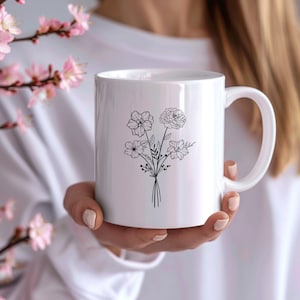 May include: White ceramic mug with a black line drawing of a bouquet of flowers. The flowers are stylized and have a simple design.