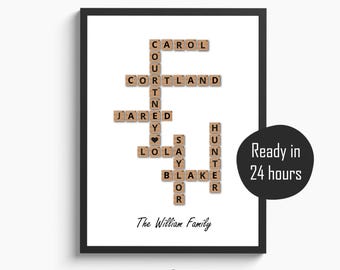 May include: A framed print with a white background features a family name crossword puzzle design. The names are spelled out using wooden letter tiles. The text "The William Family" is below the crossword. A black circle says "Ready in 24 hours."