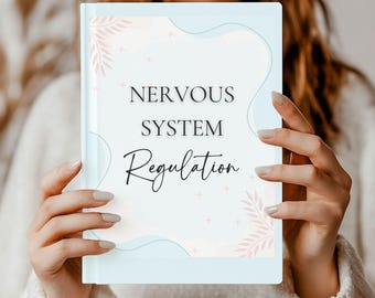 May include: A blue and pink journal with the text "NERVOUS SYSTEM Regulation" on the cover. The journal has a floral design with pink leaves and white stars.