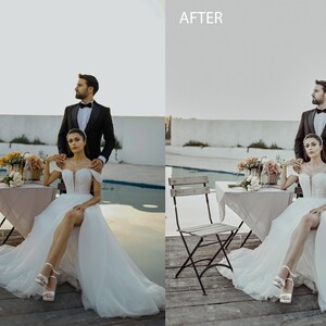 May include: A bride and groom pose for a wedding photo in front of a pool. The bride is wearing a white wedding dress with a high slit and the groom is wearing a black tuxedo. They are standing next to a table with flowers and a chair.