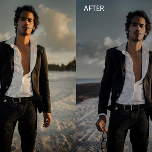 May include: A man in a black suit jacket and white shirt stands on a beach with a cigarette in his mouth. He is holding a pair of glasses in his hand.