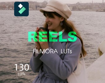 Puede incluir: Una mujer con un abrigo azul claro y un sombrero beige, sosteniendo una taza de café. La imagen incluye el texto "REELS", "FILMORA LUTS" y "130 LUTS". El logotipo de Filmora está en la esquina superior izquierda, con un cuerpo de agua y una ciudad al fondo.