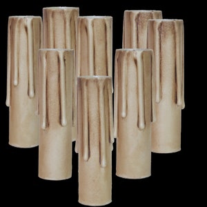 May include: Eight beige candle sleeves with a dripped wax design. The sleeves are made of a textured material and have a slightly rough surface.