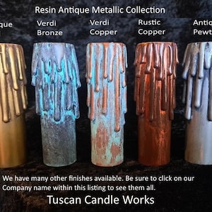 May include: A collection of five resin candle holders with an antique metallic finish. The colors include Antique Gold, Verdi Bronze, Verdi Copper, Rustic Copper, and Antique Pewter. The holders have a dripped wax design and are from Tuscan Candle Works.