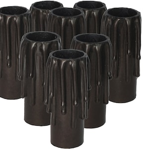 May include: Eight black dripped candle cups. The cups are made of wax and have a textured, dripped look. They are designed to be used with pillar candles.