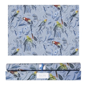 May include: A roll of blue wrapping paper and a box with a matching design. The pattern features colourful parrots and foliage on a light blue background. The box has the text "Azure Aviary" and "6 Round Dinner Liners".