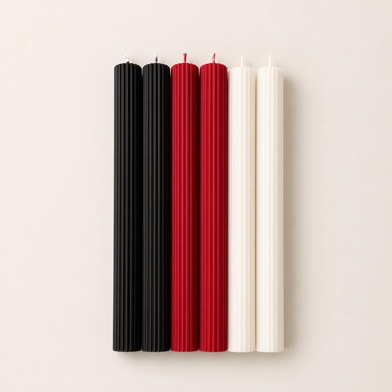 five candles of different colors: black, red, white, and two additional colors that are not visible in the image.
