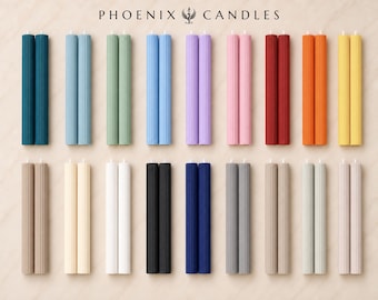 May include: A collection of sixteen pairs of fluted, cylindrical taper candles arranged in two rows. The candles come in various solid colors including blue, green, pink, red, orange, yellow, white, black, gray, and beige. The text PHOENIX CANDLES is centered at the top.