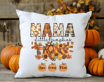 May include: White throw pillow with the text "Mama Little Pumpkins" in colorful patchwork letters. The pillow features a fall-themed design with pumpkins, sunflowers, and leaves. The names "Sam", "Emma", and "Titan" are written below the design.