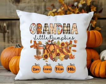 May include: White throw pillow with the text "Grandma Little Pumpkins" in colorful patchwork letters. The pillow features a fall-themed design with pumpkins, sunflowers, and leaves. The names "Sam", "Emma", "Titan", and "Mila" are printed in a circle around the bottom of the pillow.