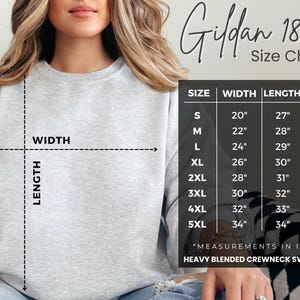 May include: Size chart for Gildan 18000 heavy blended crewneck sweatshirt. The chart shows measurements in inches for width, length, and sleeve length for sizes S through 5XL.