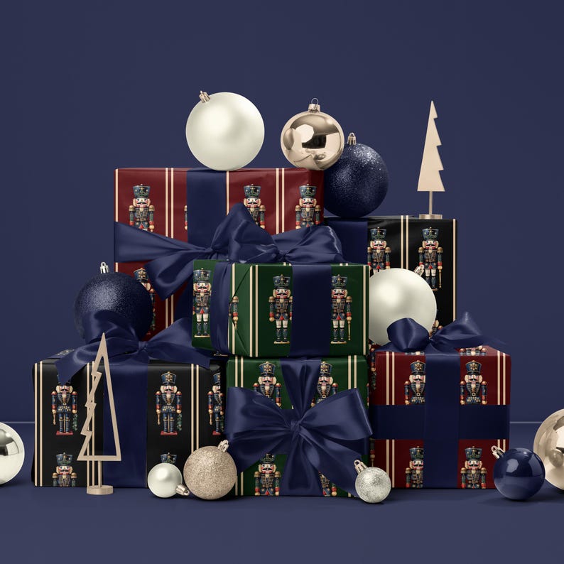 May include: A collection of wrapped gifts with navy blue bows, featuring nutcracker-themed wrapping paper in red, green, and black. Decorative ornaments and tree-shaped decor complete the holiday scene.