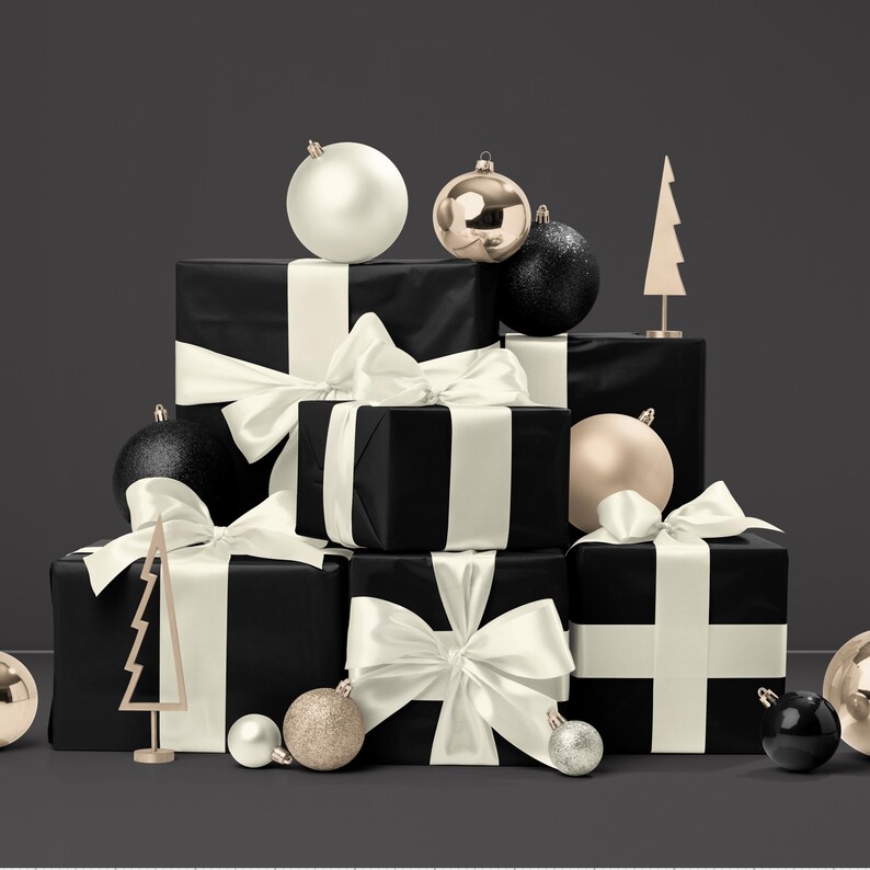 May include: A collection of black wrapped gift boxes with ivory satin ribbons and bows. The gifts are adorned with gold, silver, and black Christmas ornaments, and small gold tree decorations. The background is a dark gray.