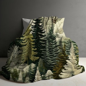 May include: A white throw blanket with a forest scene printed on it. The design features a variety of green trees and foliage, creating a lush and natural look.