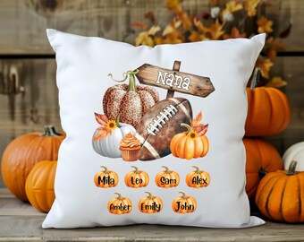 May include: White pillow with a football, pumpkins, and a sign that says "Nana". The pillow also has the names Mila, Leo, Sam, Alex, Amber, Emily, and John printed on it.
